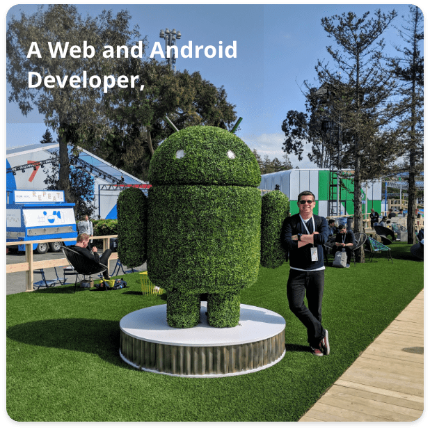 derek pastor standing next to an android statue